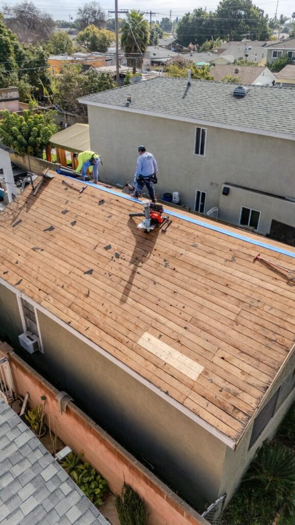 Victorville roofing expert demonstrating professional nail gun technique during roof replacement